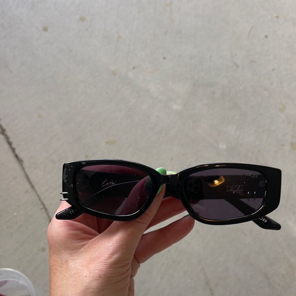 Dezi sunglasses with piercings.